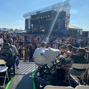 The view from an accessible platform looking toward an outdoor concert stage.